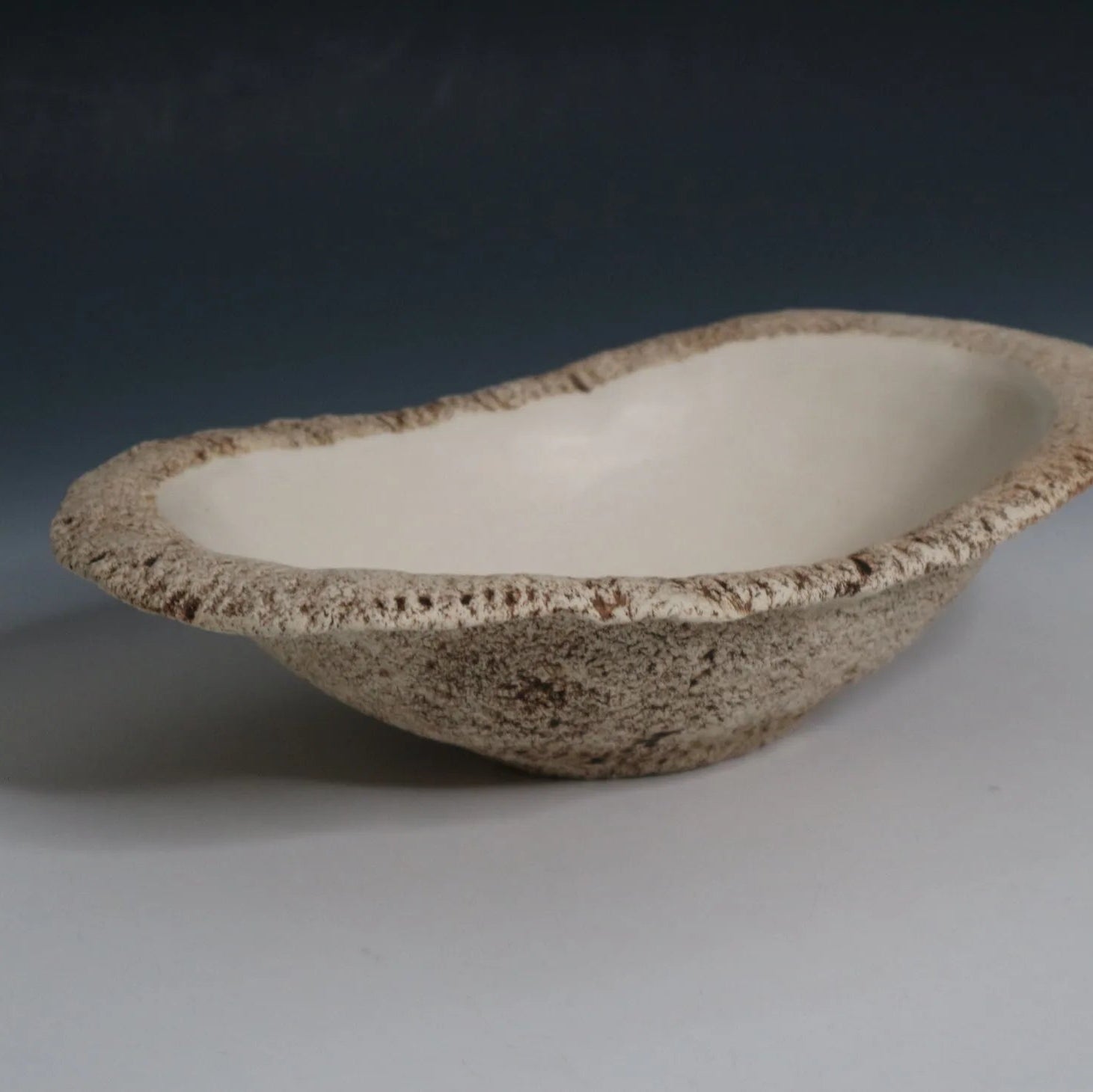 Hakuwa white oval bowl made from Japanese semi-porcelain and clay, handcrafted tableware for modern dining.