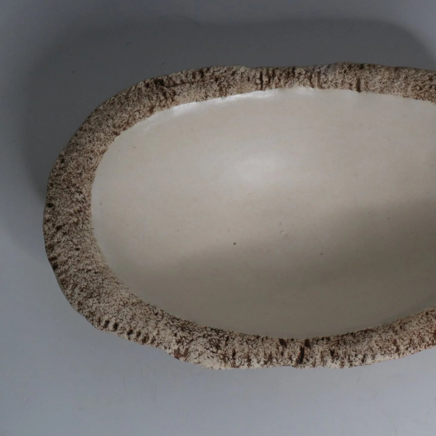 Hakuwa white oval bowl made from Japanese semi-porcelain and clay, handcrafted tableware for modern dining.