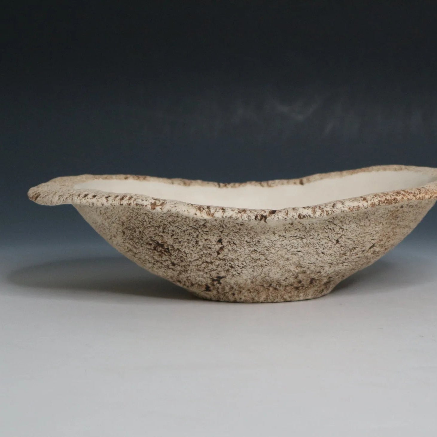 Hakuwa white oval bowl made from Japanese semi-porcelain and clay, handcrafted tableware for modern dining.