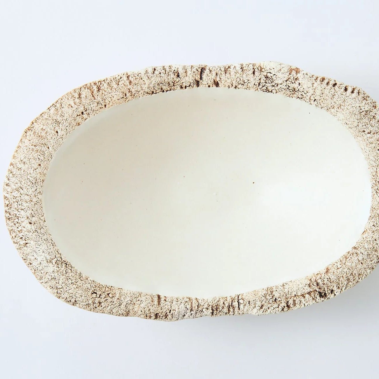Hakuwa white oval bowl made from Japanese semi-porcelain and clay, handcrafted tableware for modern dining.