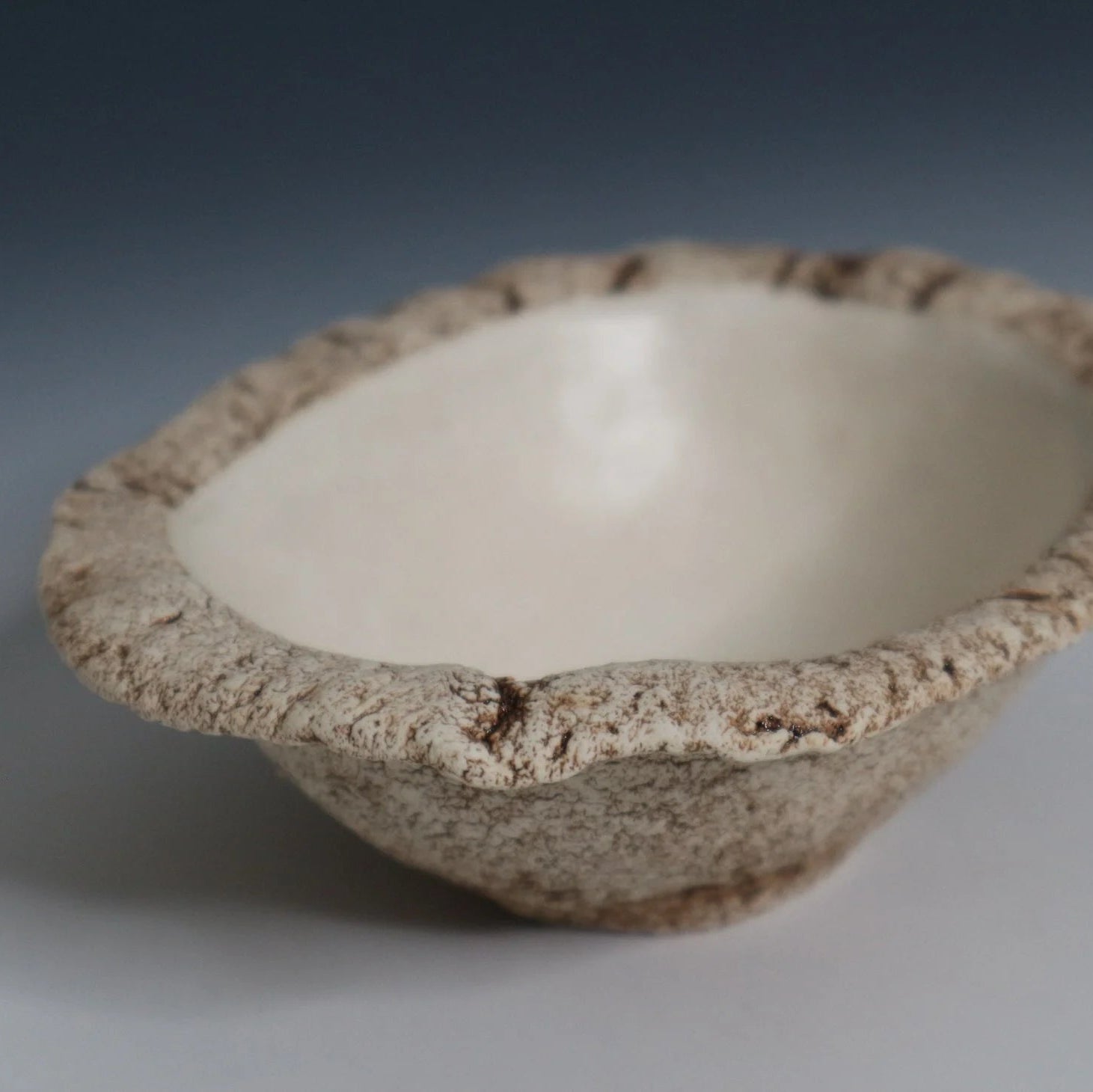 Hakuwa white oval bowl made from Japanese semi-porcelain and clay, handcrafted tableware for modern dining.