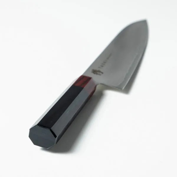 Kaizen 8.5-inch Japanese chef knife with lightweight blade and octagonal handle for precision cutting.
