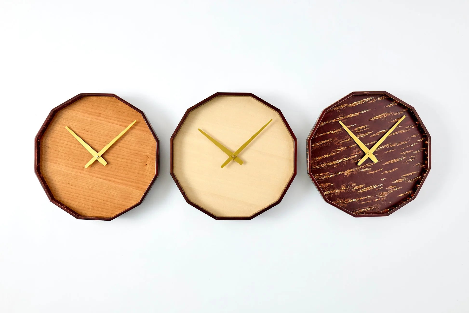 Mokuroku 12-sided Japanese wooden wall clock made of cherry wood with minimalist design and brass hands, handcrafted in Japan.