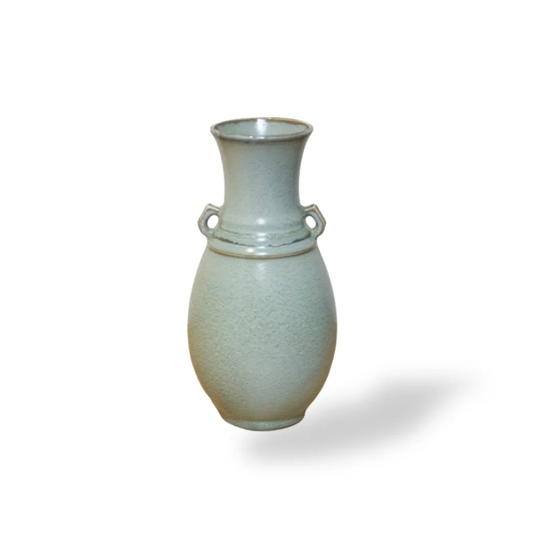 Ceramic vase with a textured surface on a white background