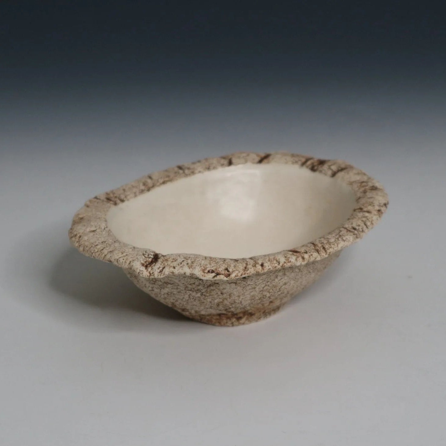 Hakuwa white oval bowl made from Japanese semi-porcelain and clay, handcrafted tableware for modern dining.