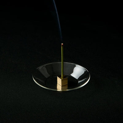 Japanese brass cube incense holder with glass plate, minimalist zen decor for home or meditation space.