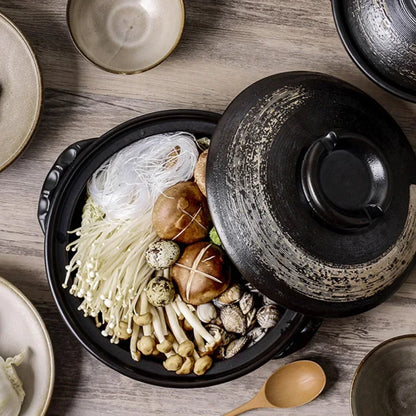 Traditional Japanese donabe clay pot with rustic design, perfect for slow-cooked meals and family-style serving.