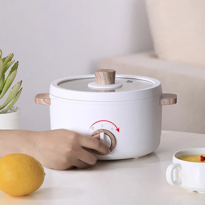 Japanese multi-functional electric mini cooker boiling pot, compact design for boiling, steaming, and cooking, perfect for small spaces.