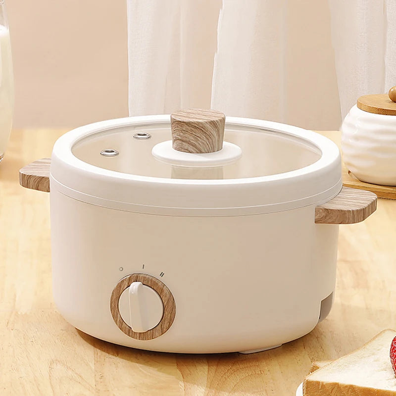 Japanese multi-functional electric mini cooker boiling pot, compact design for boiling, steaming, and cooking, perfect for small spaces.