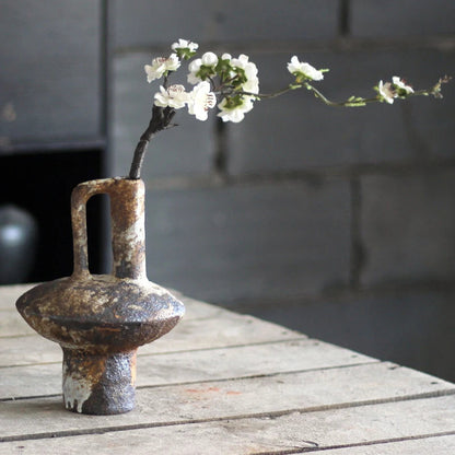 Handcrafted Japanese rough pottery ceramic vase with wabi-sabi aesthetic.