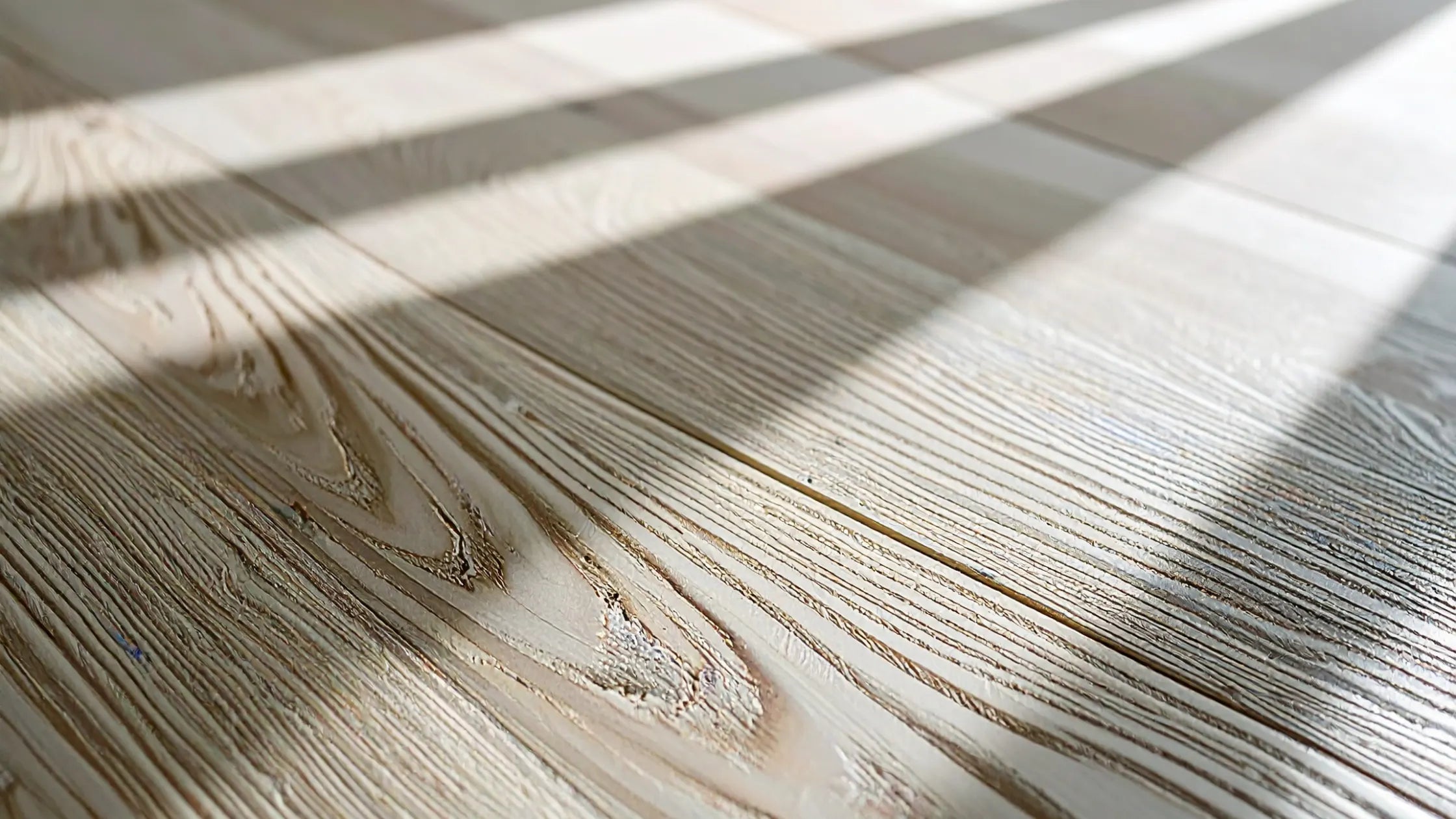 Close-up of wooden flooring with light and shadow patterns
