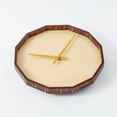 Mokuroku 12-sided Japanese wooden wall clock made of cherry wood with minimalist design and brass hands, handcrafted in Japan.