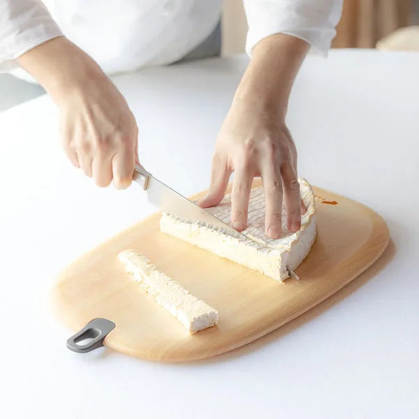 Japanese round wooden cutting board durable kitchen chopping board for food prep and serving.